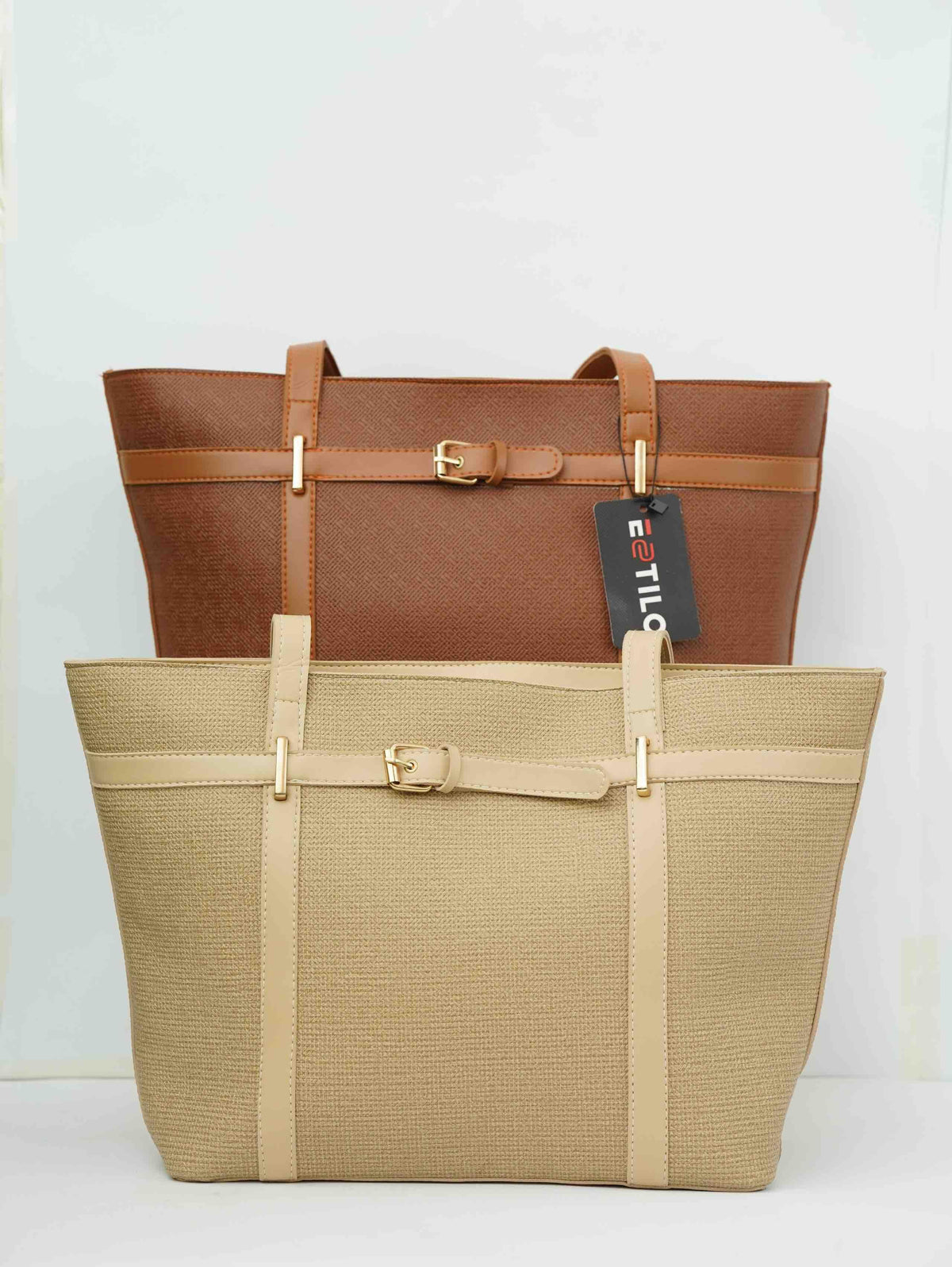 Two stylish tote bags, one tan and one brown, with gold buckles on a white background.