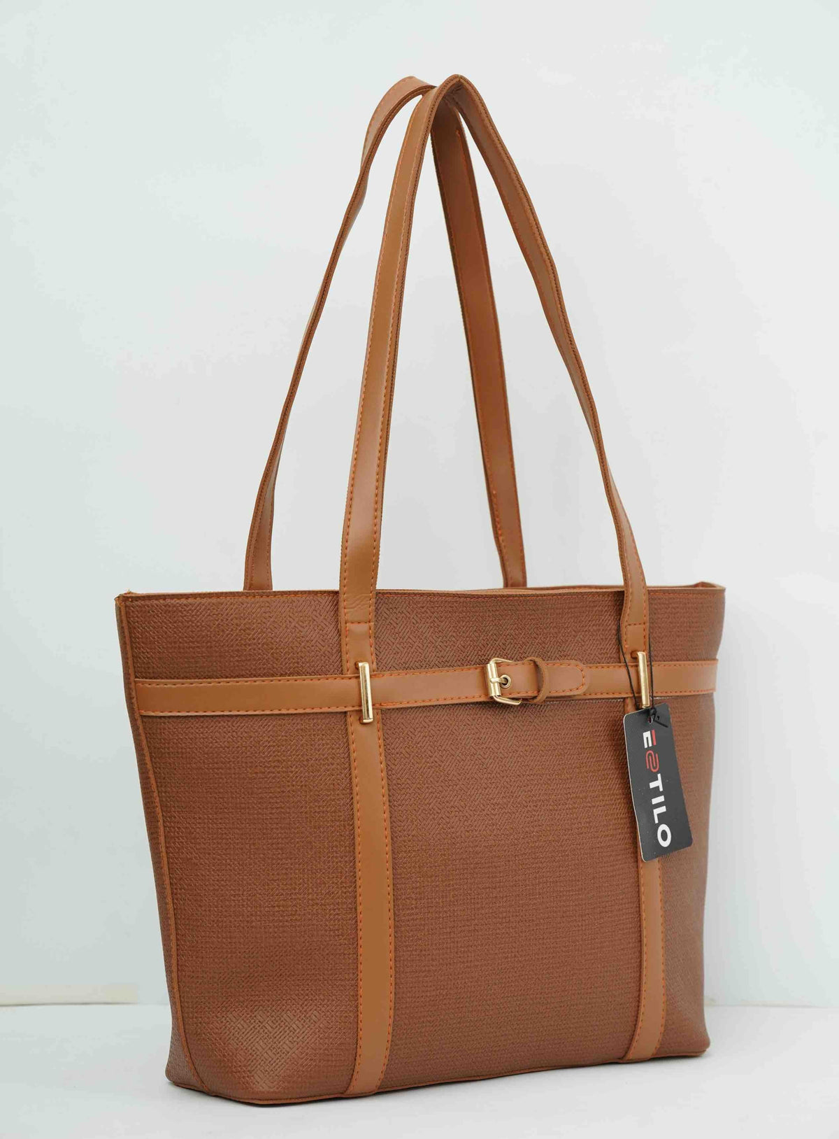Brown leather tote bag with double handles and gold buckle accents