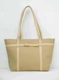 Beige woven tote bag with leather straps and gold buckle detail against white background