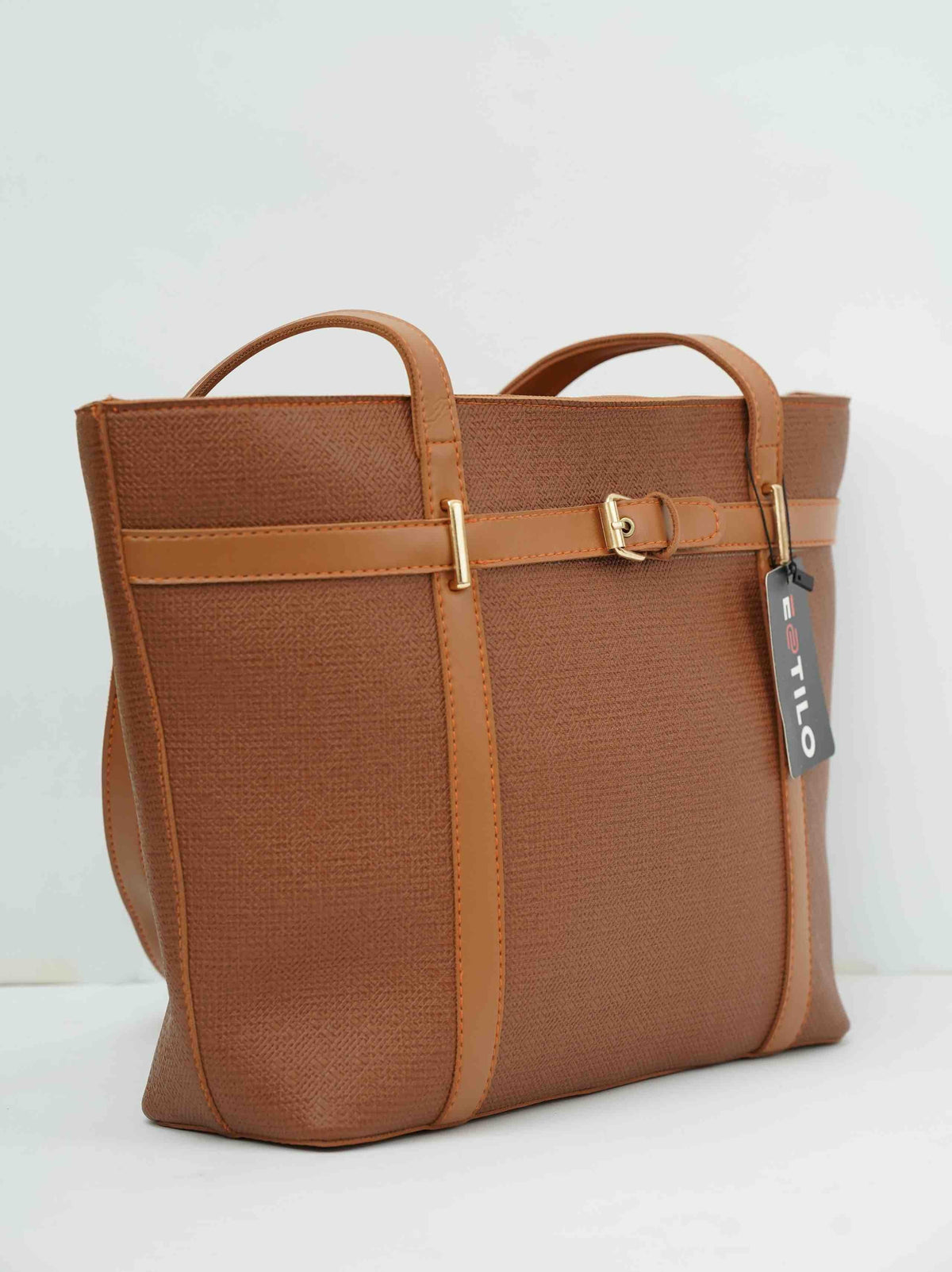 Brown textured leather tote bag with gold hardware and dual handles on a white background