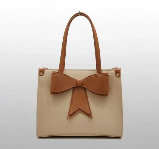 Beige tote bag with brown handles and a large brown bow on the front, minimalist style