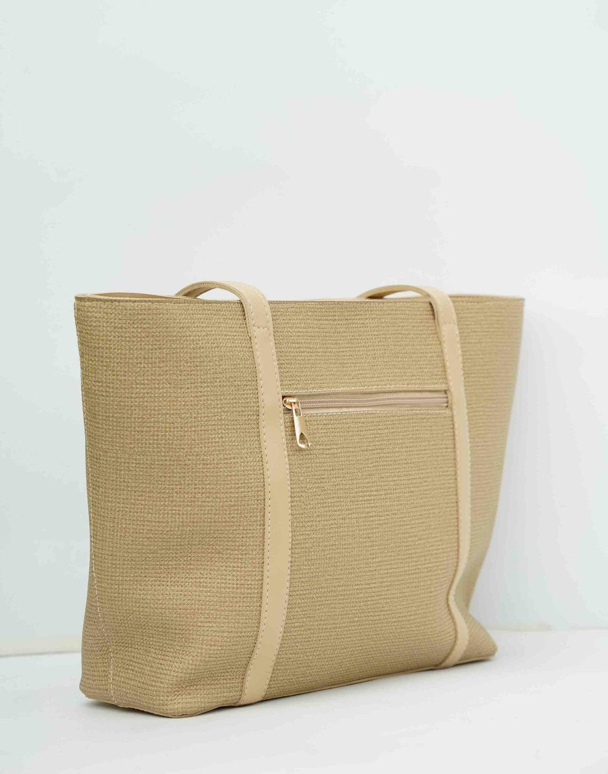 Beige woven tote bag with leather trim and exterior zipper pocket
