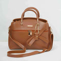Brown leather handbag with gold chain accents, front zipper, and decorative bow detail